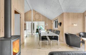 ein Esszimmer mit einem Tisch und einem Kamin in der Unterkunft Awesome Home In Sydals With 5 Bedrooms, Sauna And Private Swimming Pool in Høruphav