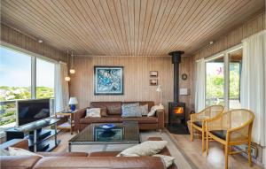 a living room with a couch and a table at Lovely Home In Glesborg With House Sea View in Bønnerup Strand