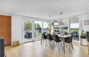 a kitchen and dining room with a table and chairs at Amazing Home In Juelsminde With Kitchen in Sønderby