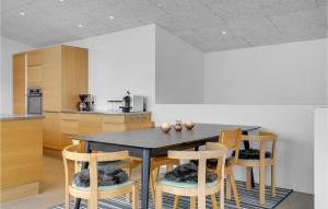 a kitchen with a black table and chairs at Amazing Home In Sjølund in Sjølund