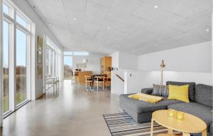 a living room with a couch and a table at Amazing Home In Sjølund in Sjølund