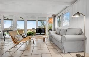 a living room with a couch and a table at Beautiful Home In Odder With Outdoor Swimming Pool in Odder