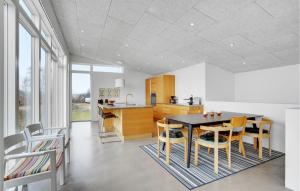 a kitchen and dining room with a table and chairs at Amazing Home In Sjølund in Sjølund