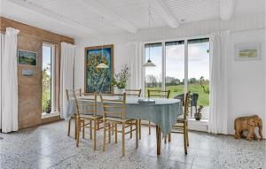 a white dining room with a table and chairs at Holiday Home Sønderskovvej in Illebølle +17 photos