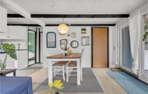 a kitchen and living room with a table and chairs at Stunning Home In Aakirkeby With Wifi in Vester Sømarken