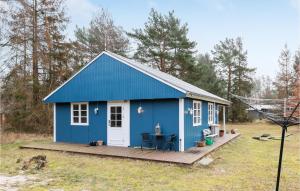 a blue tiny house with a deck at Stunning Home In Aakirkeby With Wifi in Vester Sømarken