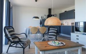 a kitchen with a table and chairs in a room at Gorgeous Apartment In Allinge With Wifi in Allinge
