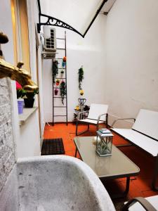 a room with two chairs and a table and a window at Rjgal Apartment B&B in Florence