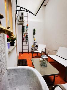 a room with two chairs and a table and a window at Rjgal Apartment B&B - Private Courtyard Florence Center in Florence