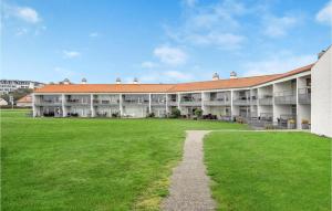 an exterior view of a large building with a grass field at Beautiful Apartment In Ebeltoft With 2 Bedrooms, Sauna And Wifi in Ebeltoft