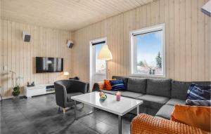 a living room with a couch and a table at Three-Bedroom Holiday Home In Ronde in Rønde