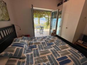 a bed with a teddy bear sitting on top of it at Biser lux - Kotor Bay - Sea view & Swimming Pool in Kamenarovići