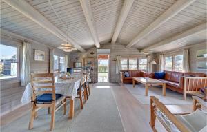 a living room with a table and a couch at Gorgeous Home In Rudkøbing With Wifi in Spodsbjerg
