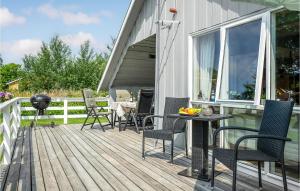 a patio with chairs and a table on a deck at Three-Bedroom Holiday Home In Dannemare in Dannemare