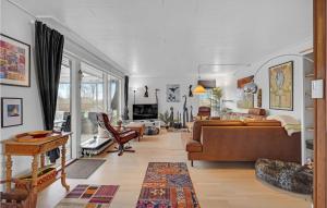 a living room with a couch and a table at 3 Bedroom Nice Home In Tranekær in Tranekær