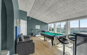 a living room with a pool table and a couch at Gorgeous Home In Spttrup With House Sea View in Lihme