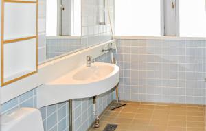 a bathroom with a sink and a mirror at Golfparken in Løjt