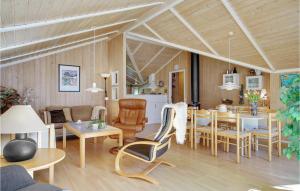 a living room with a table and a dining room at Gorgeous Home In Gedser With Sauna in Gedser