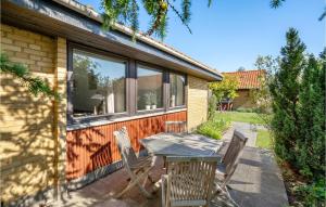 a table and chairs on the patio of a house at 1 Bedroom Cozy Home In Nrre Nebel in Nymindegab