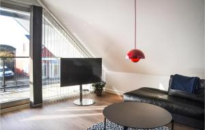 a living room with a couch and a large window at Amazing Apartment In Vejers Strand With 2 Bedrooms And Wifi in Vejers Strand