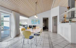 a kitchen and living room with a table and chairs at Awesome Home In Jerup With 4 Bedrooms, Sauna And Private Swimming Pool in Jerup