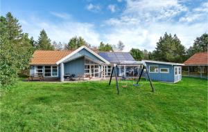 a house with a playground in the yard at Awesome Home In Jerup With 4 Bedrooms, Sauna And Private Swimming Pool in Jerup