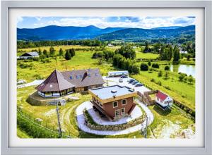 an aerial view of a house in a field at Apartamenty Przy Chacie na Głowie in Miłków