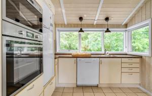 a kitchen with white cabinets and a sink and windows at Holiday Home Vemb With Fireplace 07 in Vemb +20 photos