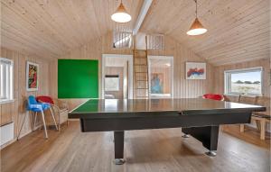 a ping pong table in the middle of a room at Cozy Home In Fan With Sauna in Sønderho