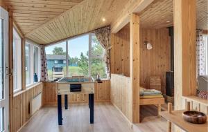 a wooden house with a desk in a room with a window at Two-Bedroom Holiday Home In Saby in Sæby