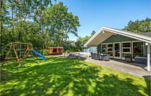 a yard with a slide and a playground at 4 Bedroom Stunning Home In Oksbl in Ovtrup