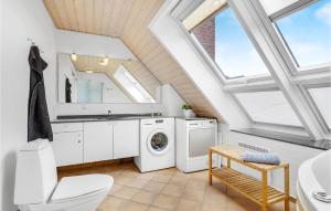 a bathroom with a washing machine and a sink at Cozy Home In Rm With Kitchen in Rømø Kirkeby