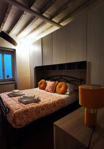 a bedroom with a bed with pillows on it at Rjgal Apartment B&B in Florence