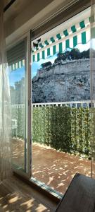 a sliding glass door with a view of the mountains at Gran apartamento cerca del mar y Castillo in Denia