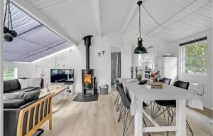a white living room with a table and a fireplace at Beautiful Home In Thisted With 2 Bedrooms And Wifi in Nørre Vorupør