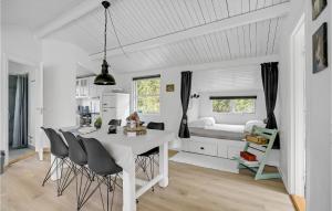 a kitchen and dining room with a white table and chairs at Beautiful Home In Thisted With 2 Bedrooms And Wifi in Nørre Vorupør