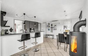 a kitchen with a fireplace in the middle of a room at Holiday Home Fiskervej Thisted Iv in Thisted