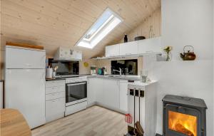 a kitchen with white appliances and a stove in it at Holiday Home Tranebærvej Thisted Iv in Nørre Vorupør