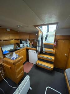 a kitchen with a sink and stairs in a boat at Luxury boat in Chertsey