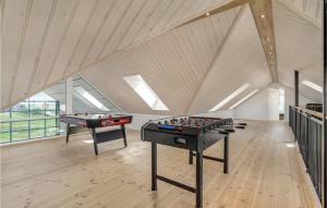 two ping pong tables in a room with an attic at Stunning Home In Harboøre With Sauna in Harboør