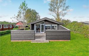 a small house in a field of grass at Awesome Home In Haderslev With 2 Bedrooms And Wifi in Diernæs