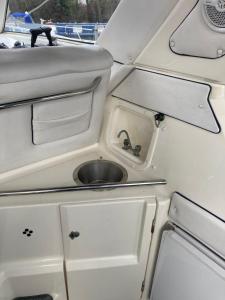 a kitchen with a sink in the back of a boat at Luxury boat in Chertsey