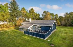 a house on a grassy field with trees at Awesome Home In Jerup With 4 Bedrooms, Sauna And Wifi in Jerup
