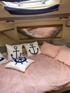 a bed with two pillows on top of it at Luxury boat in Chertsey