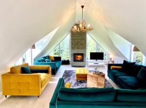 a living room with blue couches and a fireplace at The Lodge at Muir Estate in Thornhill