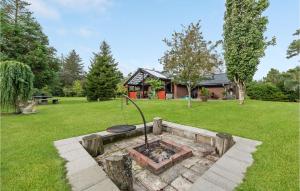 a fire pit in the middle of a yard at Beautiful Home In Blvand With 3 Bedrooms, Sauna And Wifi in Bredmose