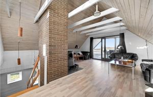 an open living room with a brick wall at Stunning Home In Ebeltoft With Wifi in Ebeltoft +23 photos