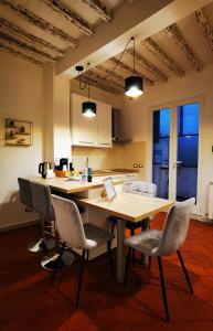 a kitchen with a wooden table and chairs at Rjgal Apartment B&B in Florence