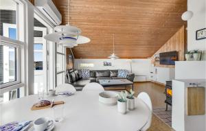 a living room with a white table and a couch at Holiday Home Grårisvej Thisted Vi in Nørre Vorupør