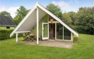 a small green house with a table in the yard at 1 Bedroom Stunning Home In Grindsted in Grindsted +15 photos